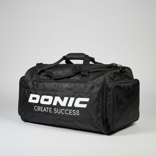 Black duffel bag with 'Bonac' branding on a pile of suitcases.