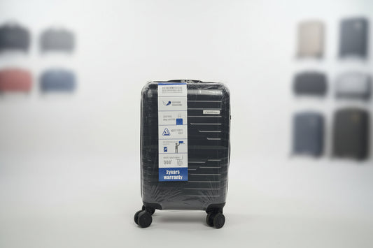 Black luggage filter with a label on a textured surface