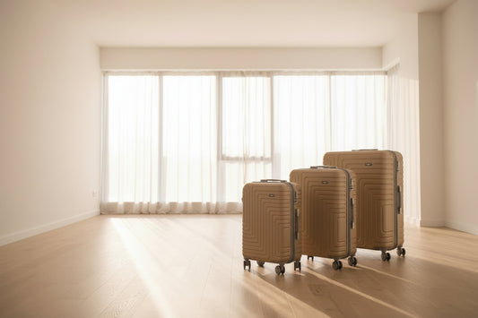 Gold suitcases with a textured pattern on wheels in a store setting