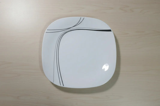 Red stool with a white circular seat featuring black lines on a tiled floor.