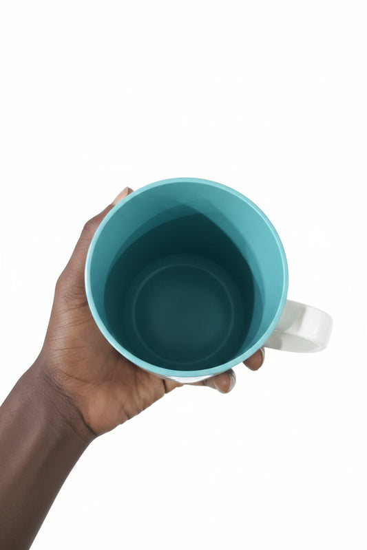 Hand holding a teal plastic cup with a background of metal parts