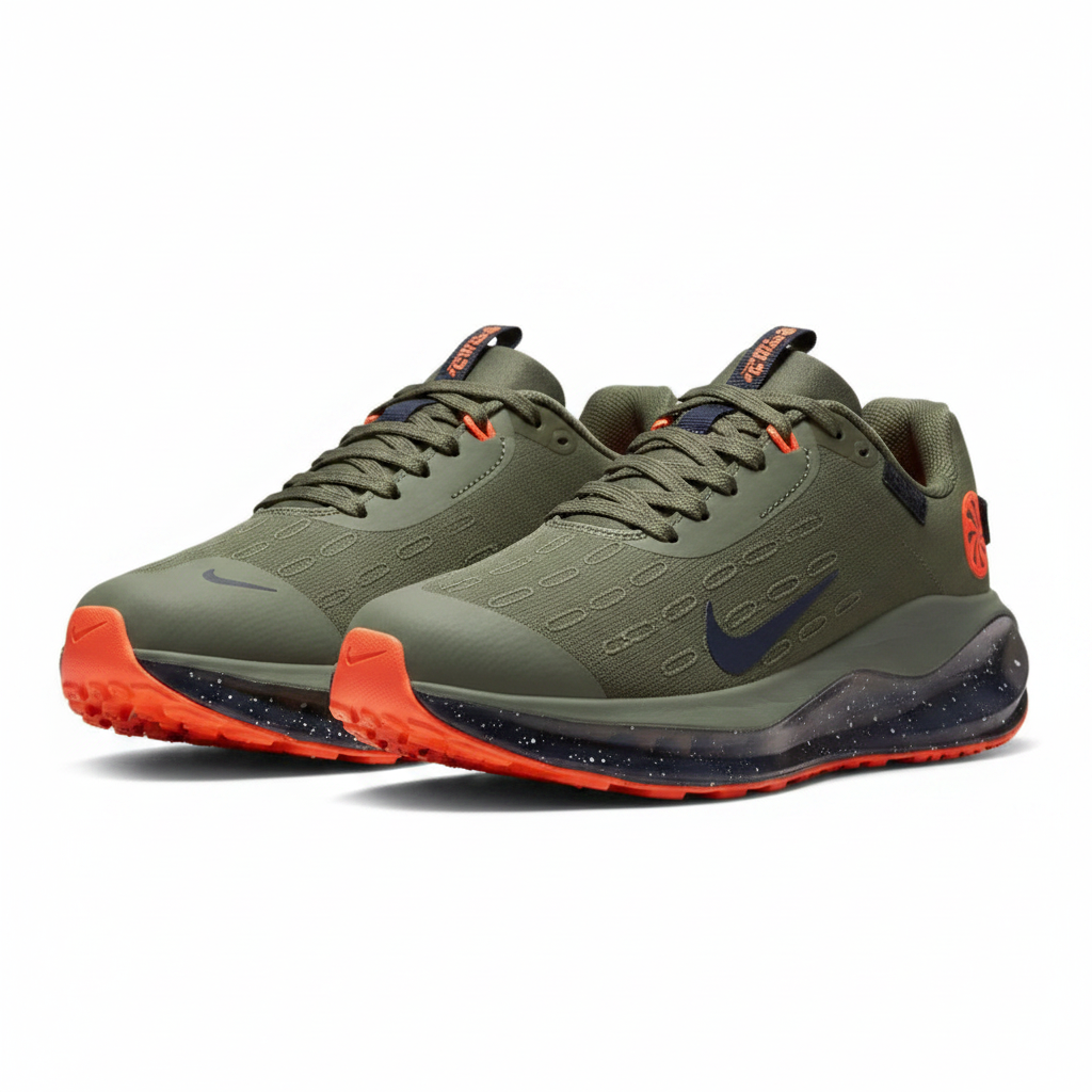 Two green running shoes with orange accents on a wooden floor.