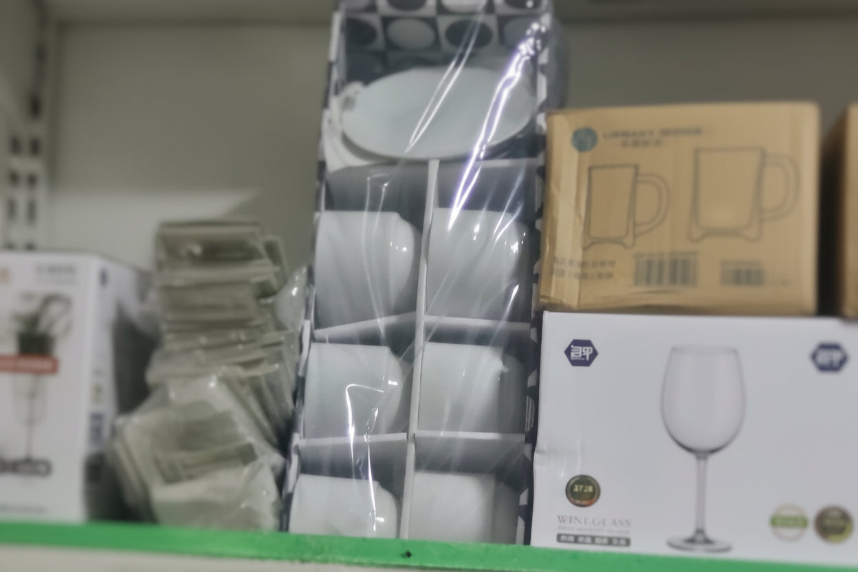 White ceramic bowls in a display case with a blurred background