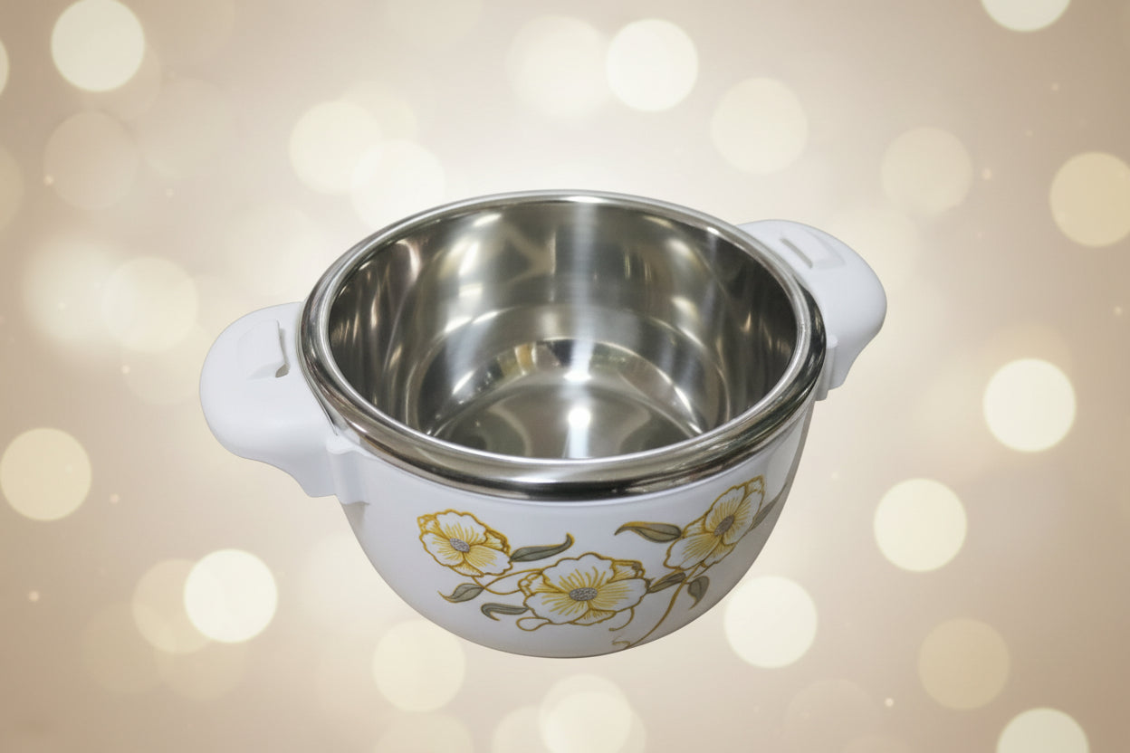 Stainless steel pot with floral design on a shelf with other kitchen items.