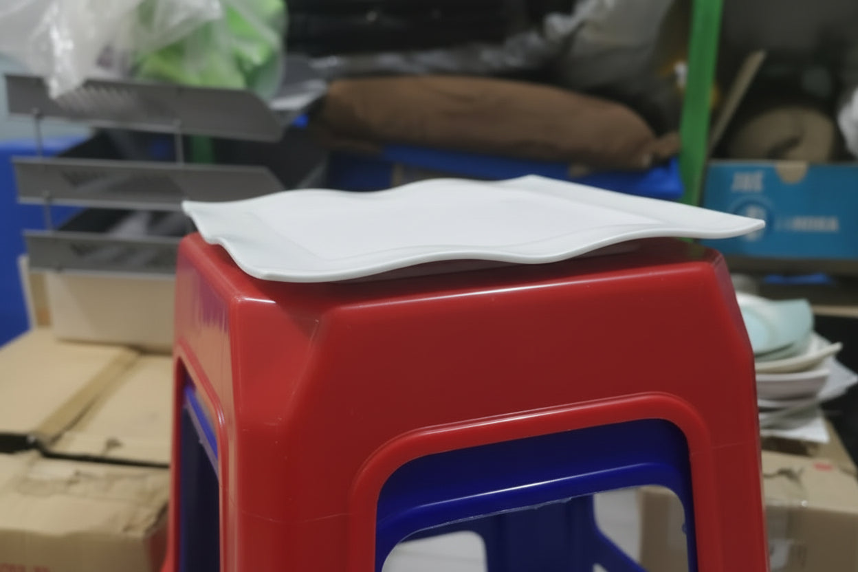 Red stool with a white plastic cover on a blurred background