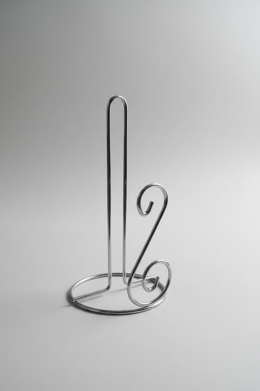 Metallic kitchen tool on a cluttered background with boxes and packaging
