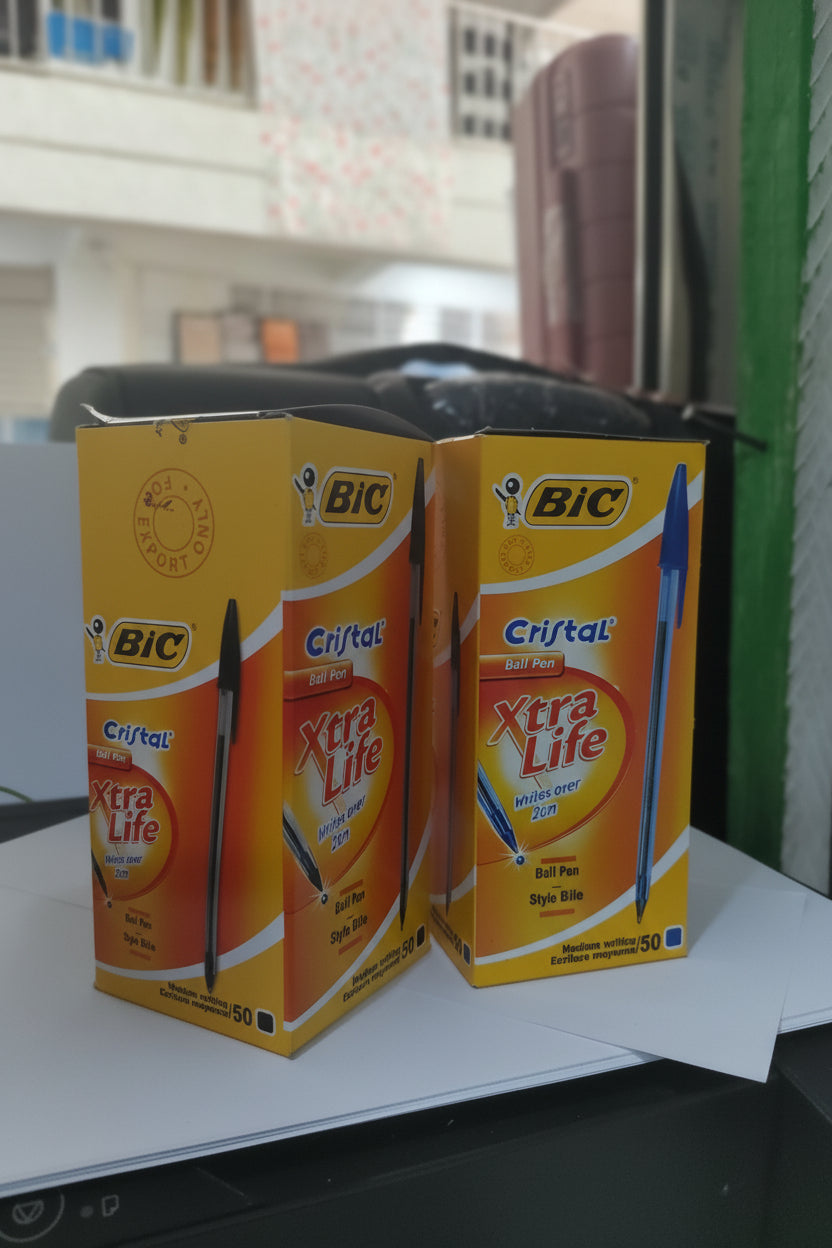 Two boxes of BIC Cristal Xtra Life pens on a shelf.