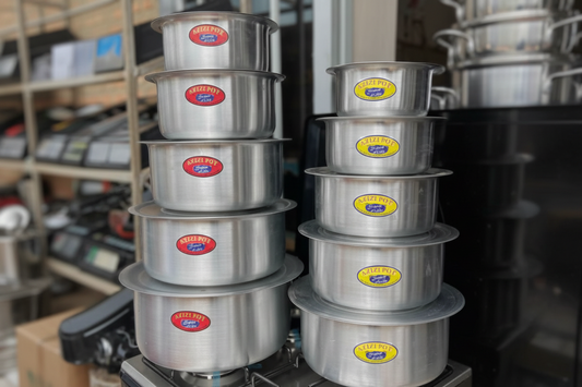 Stacks of metal pots with visible brand labels on a metal stand.