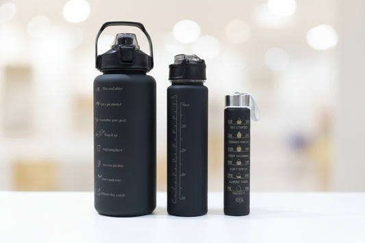 Black  bottles with measurement markings on a wooden surface.