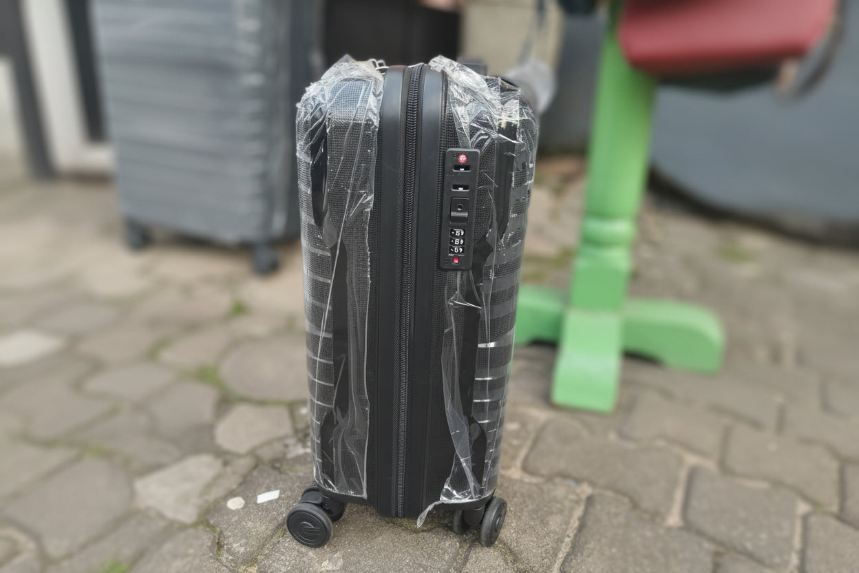 Black suitcase with a digital lock on a stone pavement