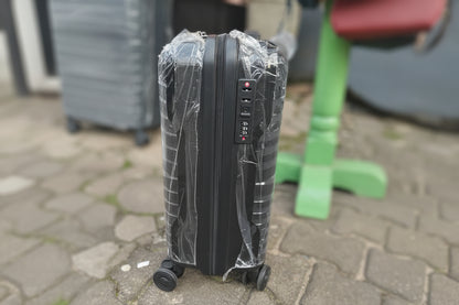 Black suitcase with a digital lock on a stone pavement