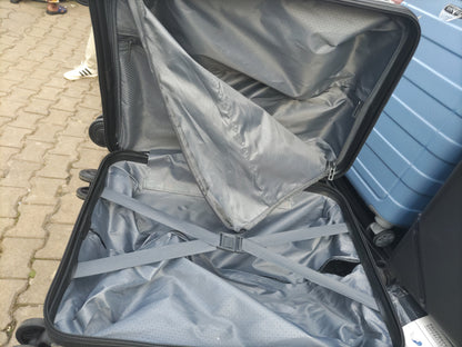 Open suitcase with interior view on a sidewalk