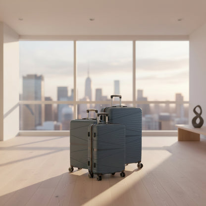 Two blue suitcases with wheels on a concrete floor in an indoor setting.
