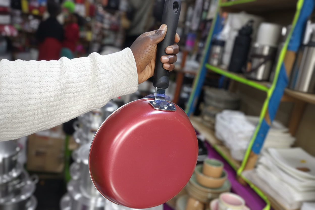 Person holding a red lid with a store shelf in the background