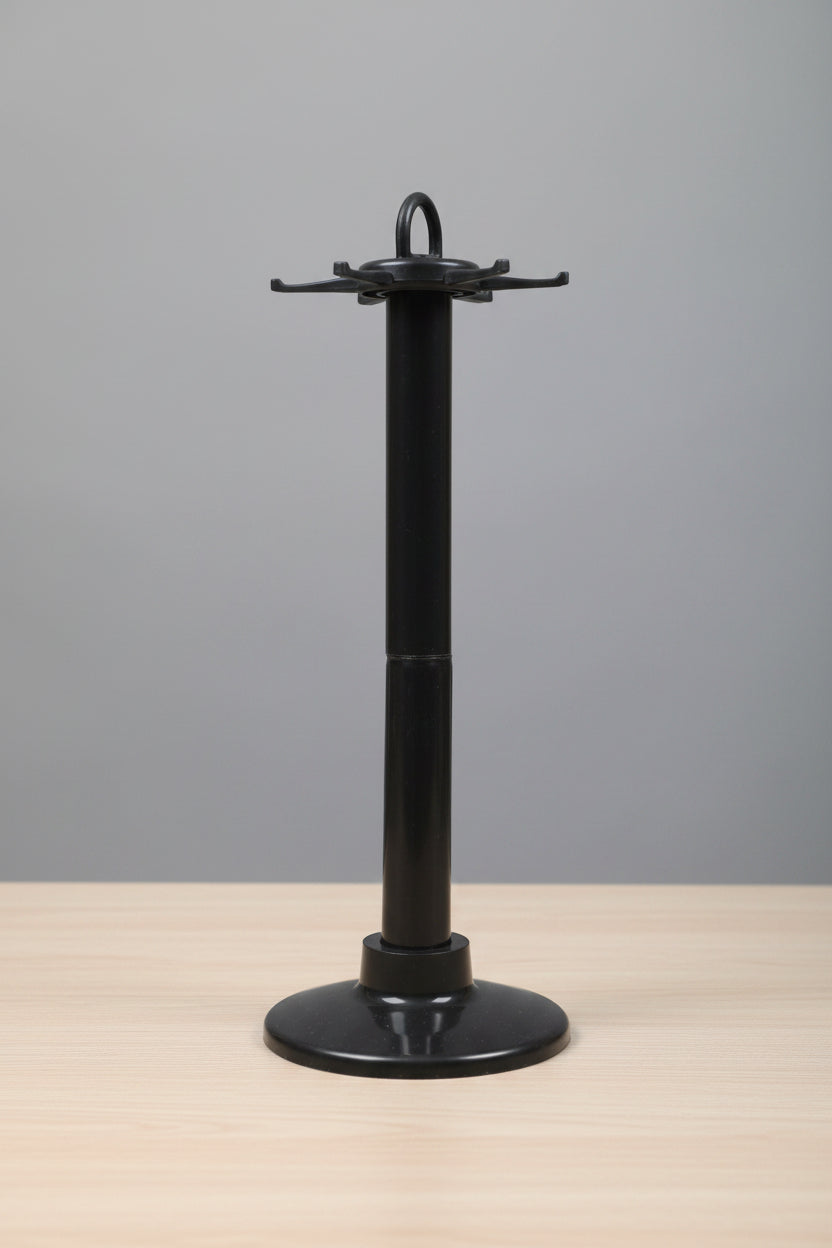  a black metal object against a blurred indoor background