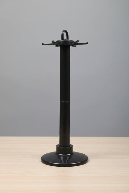  a black metal object against a blurred indoor background