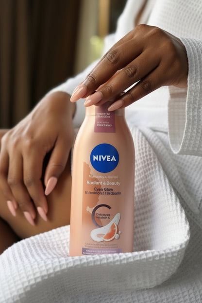 Nivea body wash bottle with a hand holding it, against a neutral background