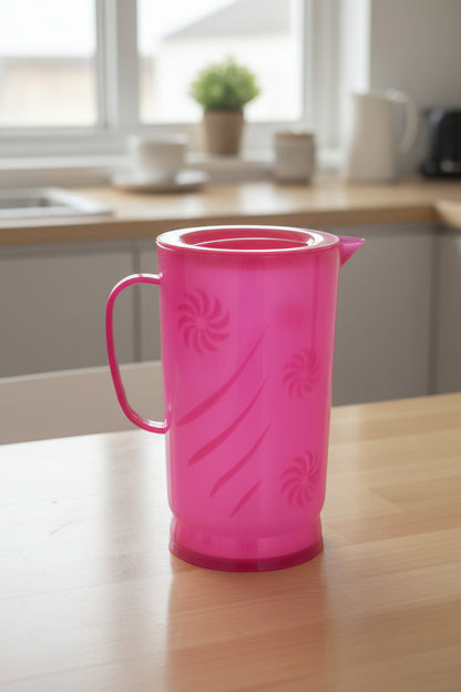Pink plastic cup held by a hand with a blurred background