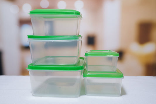 Clear plastic containers with green lids  .
