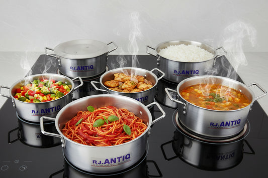 Set of metal pots with 'Antic' branding on a tiled floor.