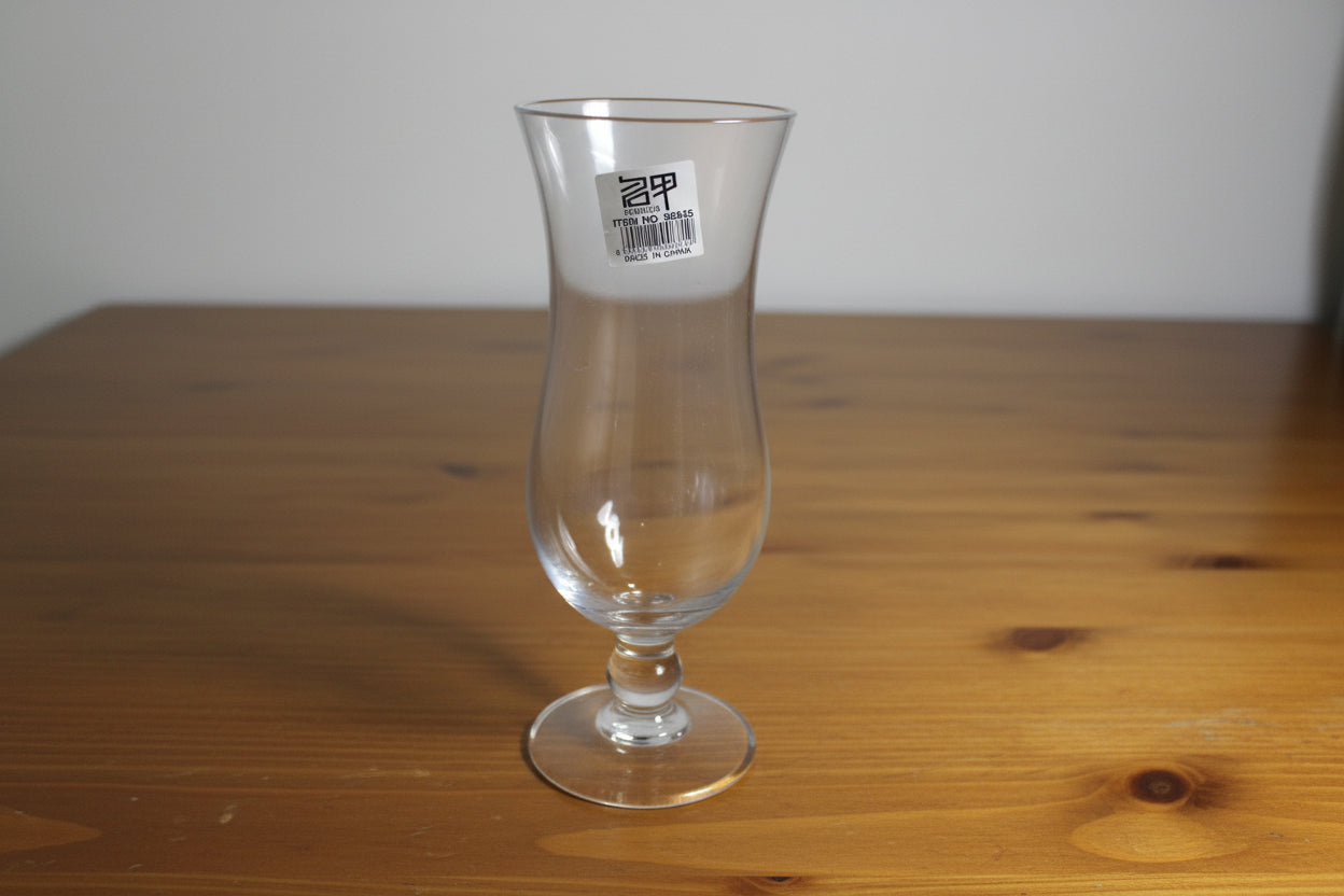 Clear glass bottle with a label on a wooden surface