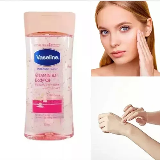 Vaseline Vitamin B3 Body Oil bottle with a woman applying oil to her hand on a white background