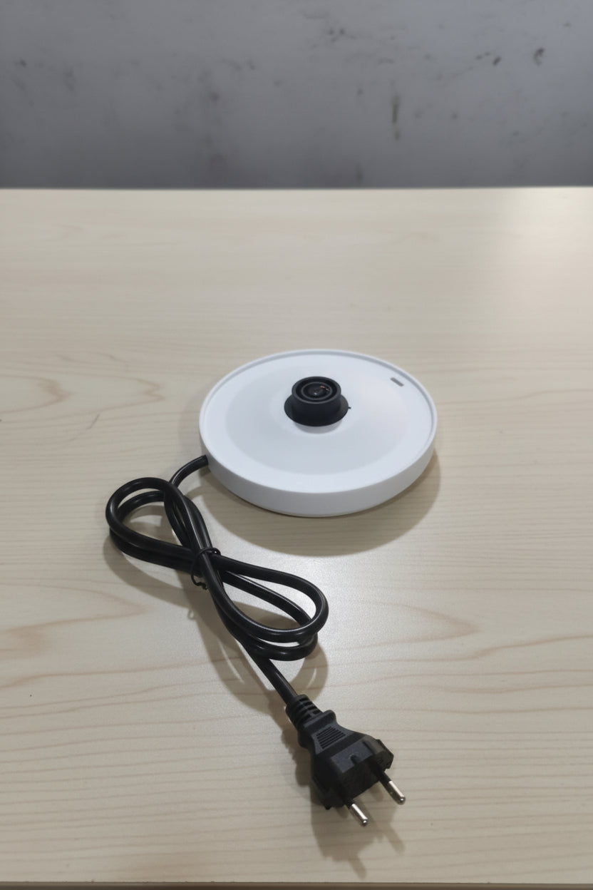 a kettle panel placed on a wooden table 
