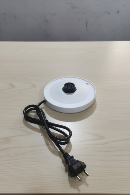 a kettle panel placed on a wooden table 
