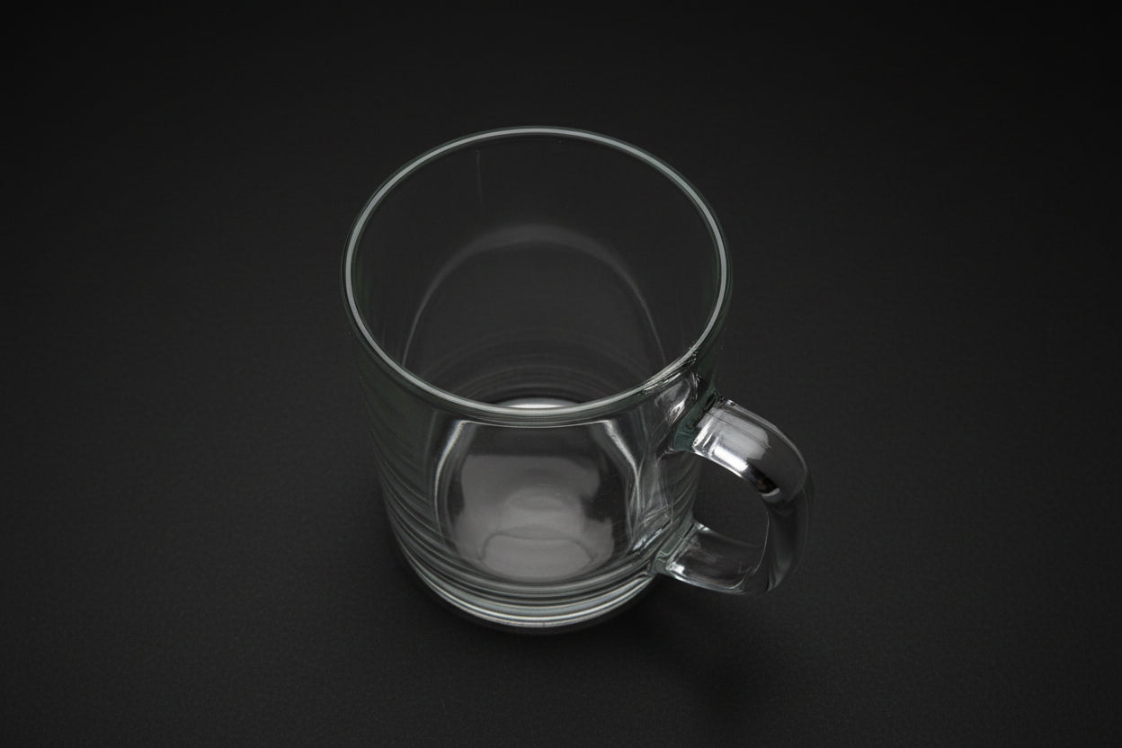 Clear glass measuring cup on a white surface 