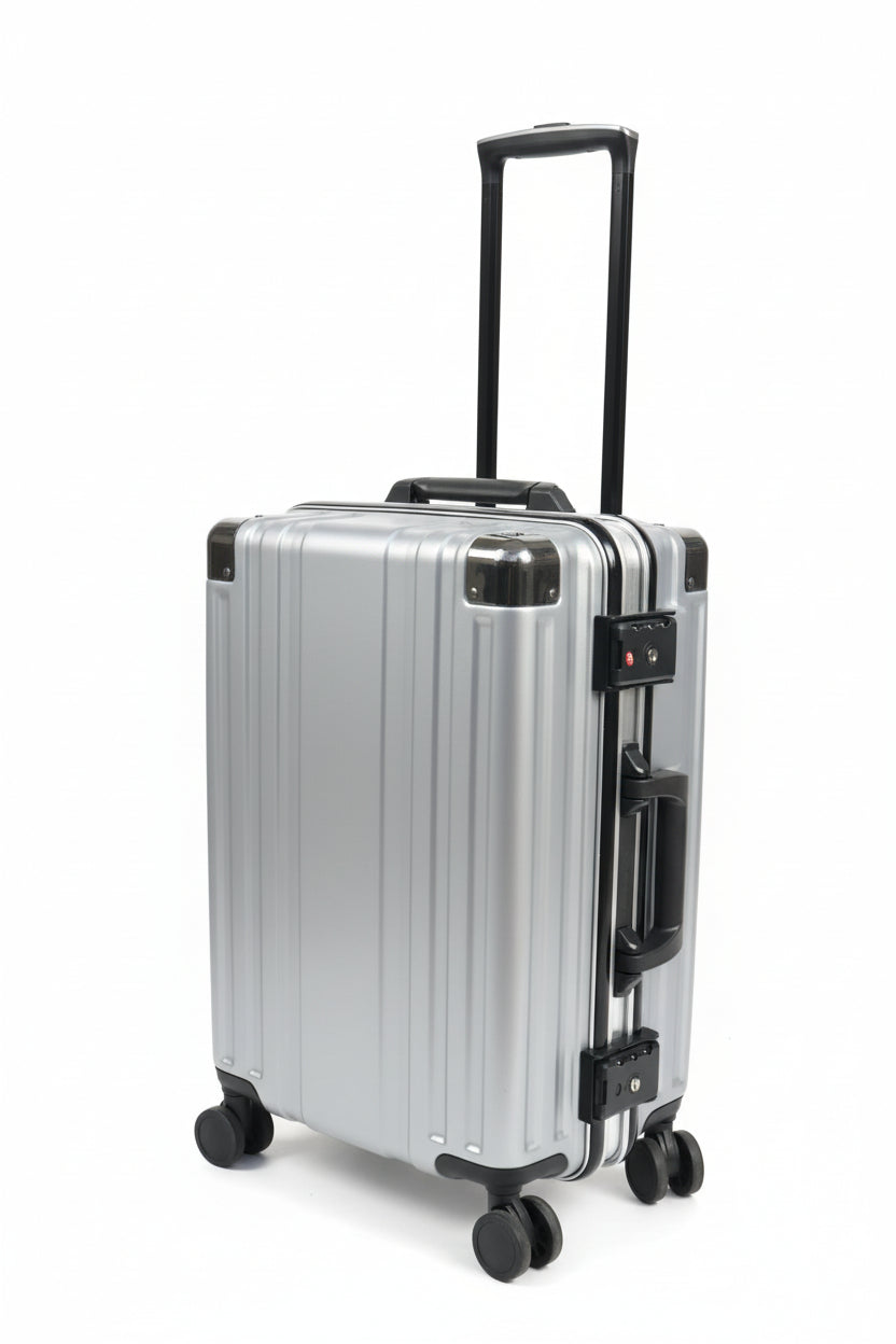 Silver suitcase with wheels on a stone pavement