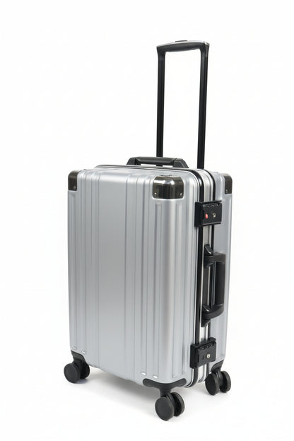 Silver suitcase with wheels on a stone pavement