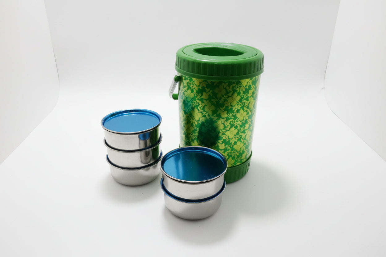 Green and silver containers on a white surface with packaging materials around
