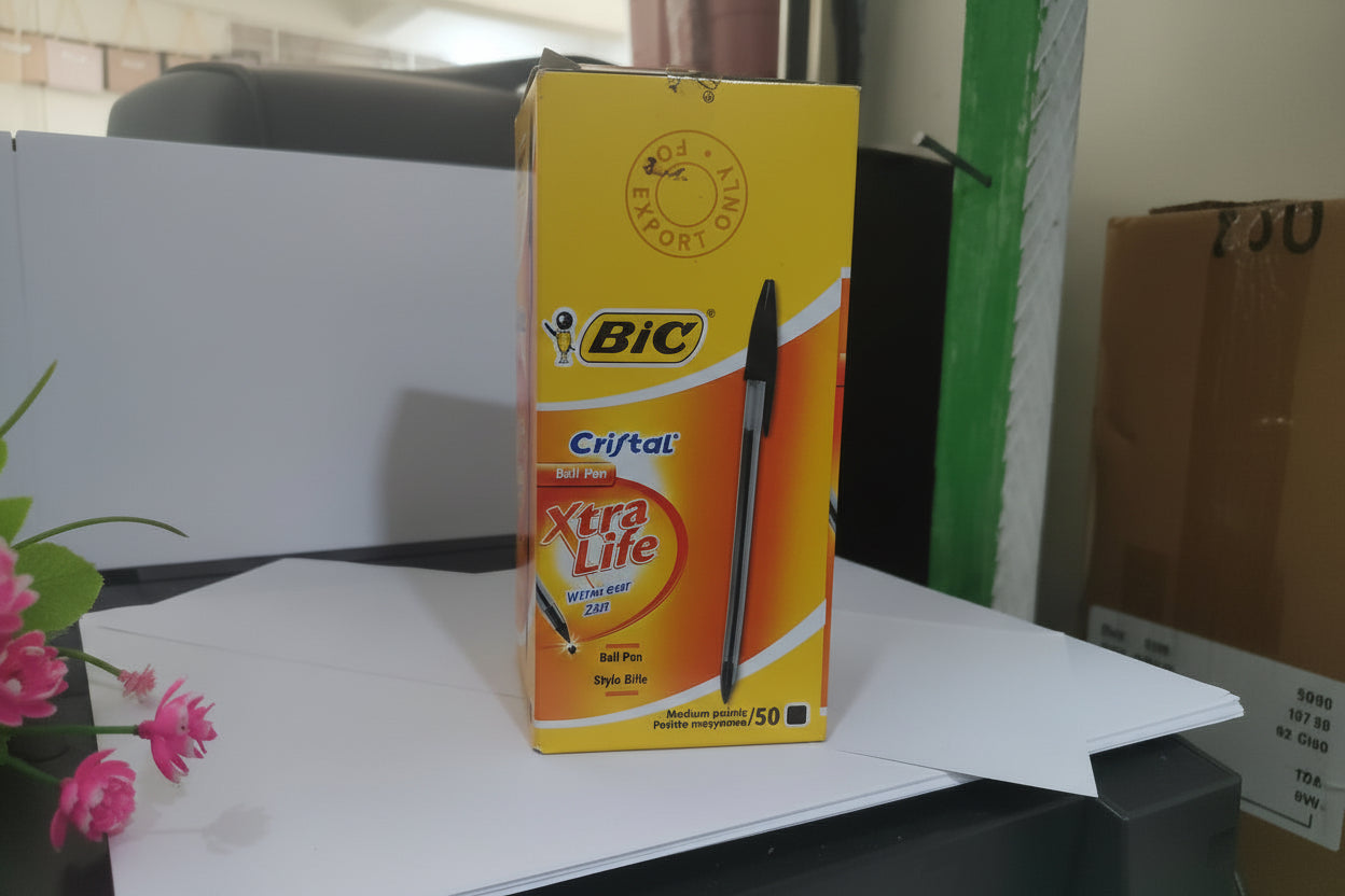 Box of BIC Cristal Xtra Life pens on a surface with a blurred background