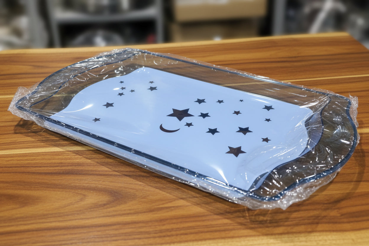 Clear plastic tray with star designs on a cluttered background