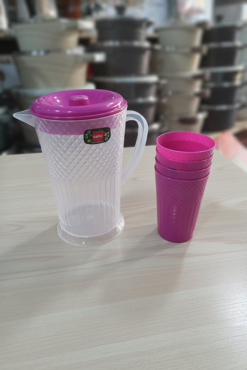 Two plastic cups with pink lids on a machine with spools in the background.