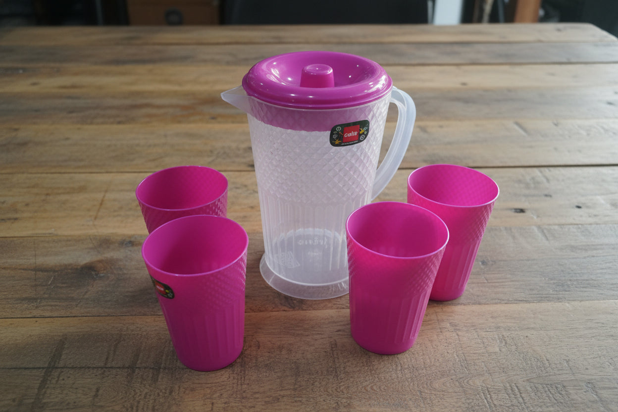 Pink plastic cups on a stand with packaging in the background