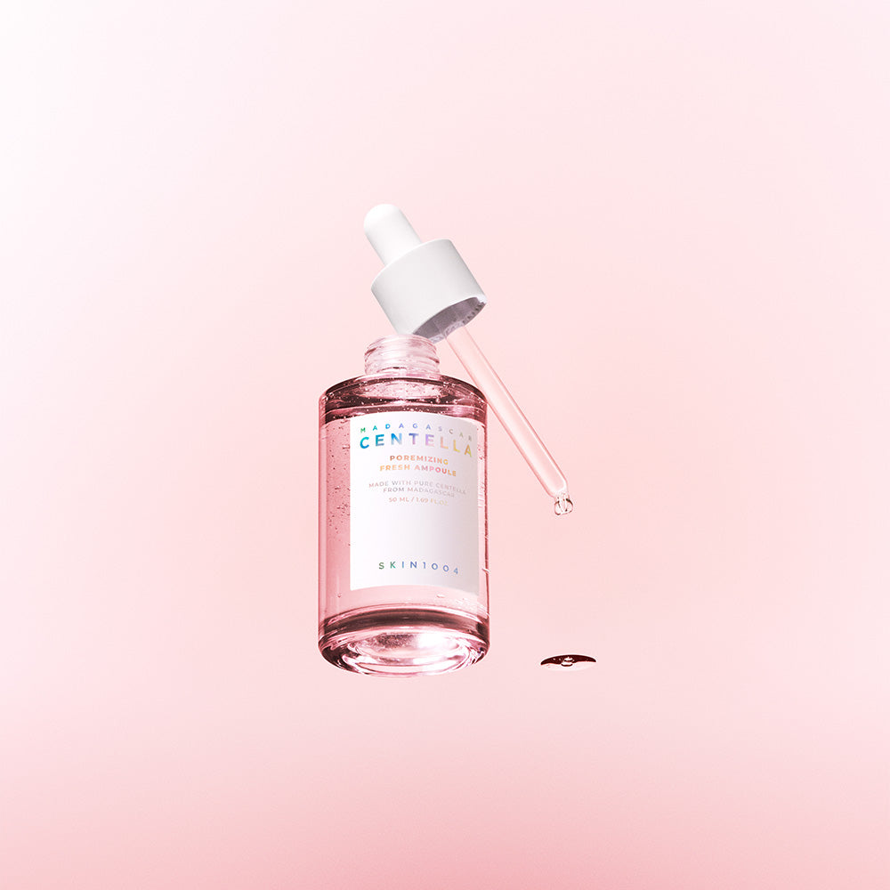 Skincare serum bottle with dropper on a pink background