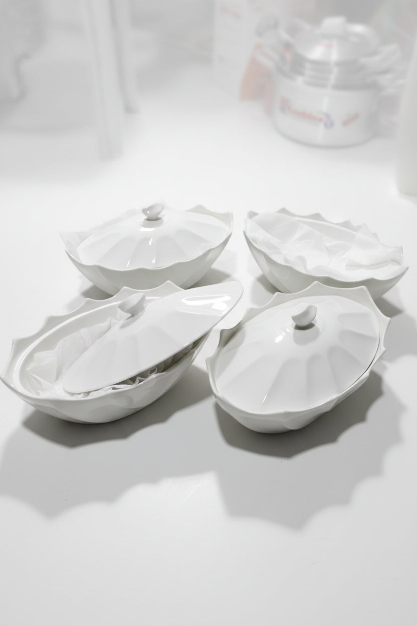 White plastic parts on a tiled floor with a branded container in the background