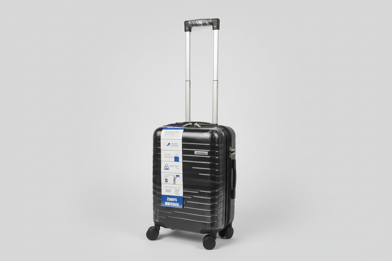 Black luggage with a label on a stone pavement