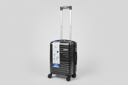 Black luggage with a label on a stone pavement
