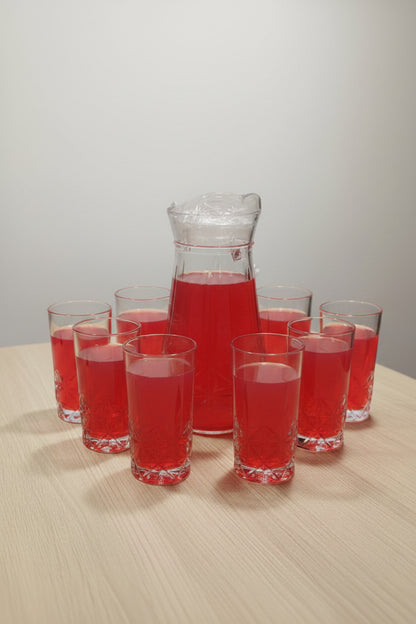 Set of clear glass tumblers on a table with a blurred background