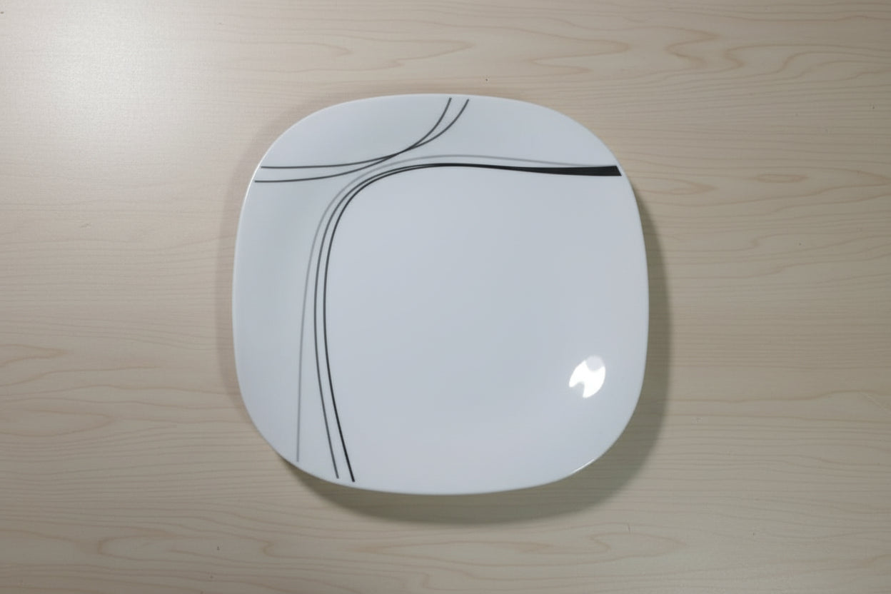Red stool with a white circular seat featuring black lines on a tiled floor.