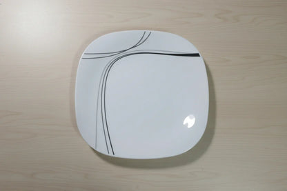 Red stool with a white circular seat featuring black lines on a tiled floor.