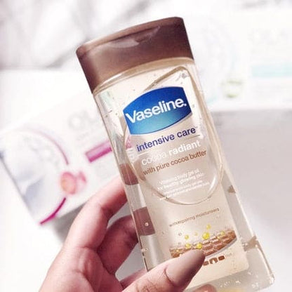 Vaseline Intensive Care bottle held in a hand with a blurred background
