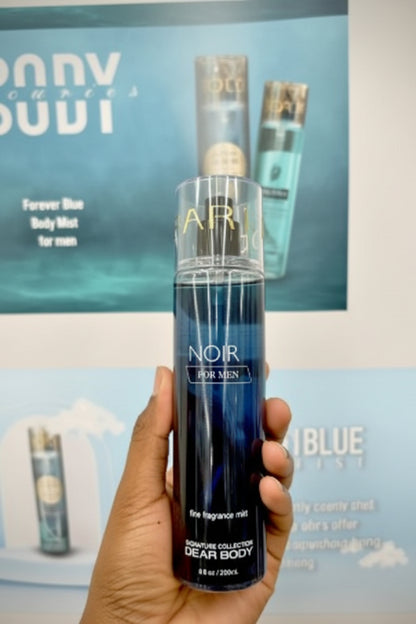 Hand holding a black perfume bottle labeled 'NOIR' with a blurred background