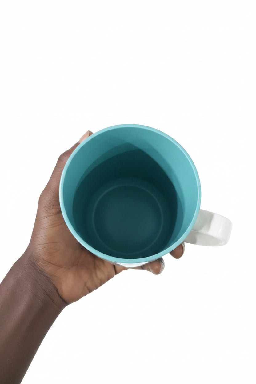 Hand holding a teal plastic cup with a background of metal parts