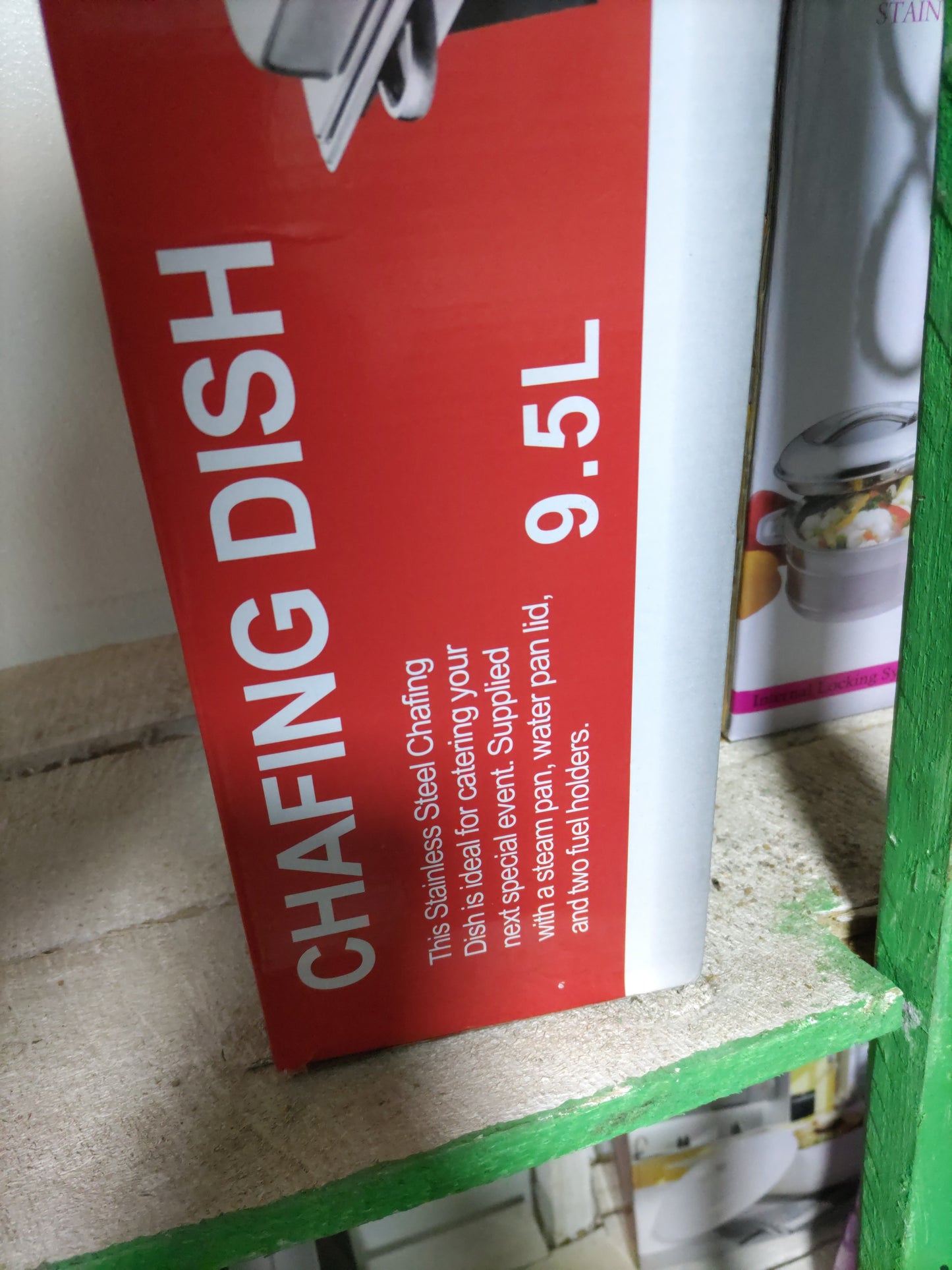 Red label with text and a graphic of a dish on a cardboard surface.