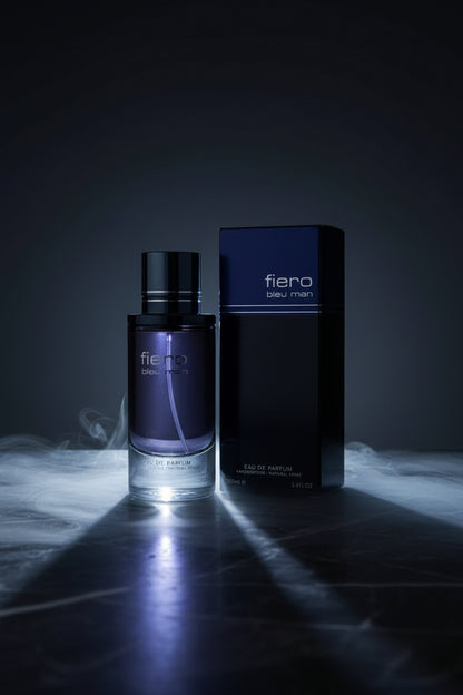 Fiero Bleu Man perfume bottle and packaging on a green surface with a blurred indoor background