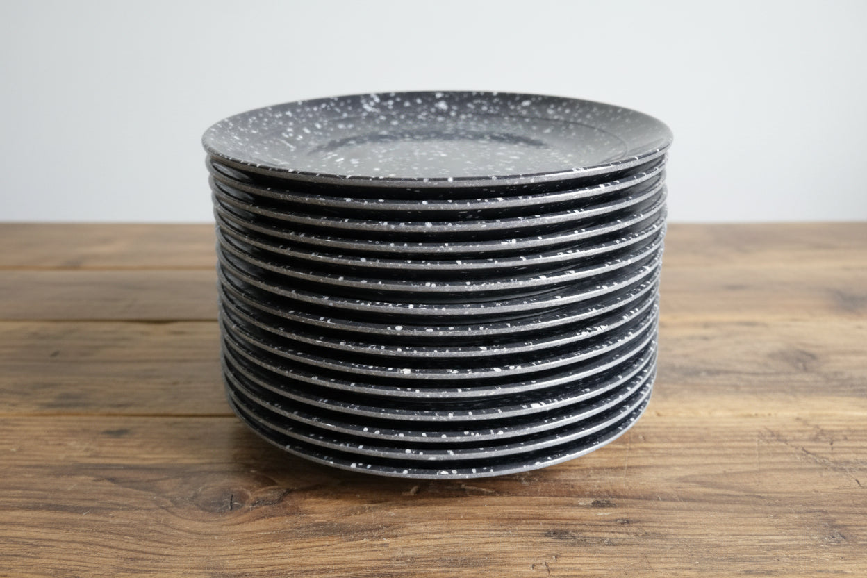 Stack of black circular objects on a wooden pallet