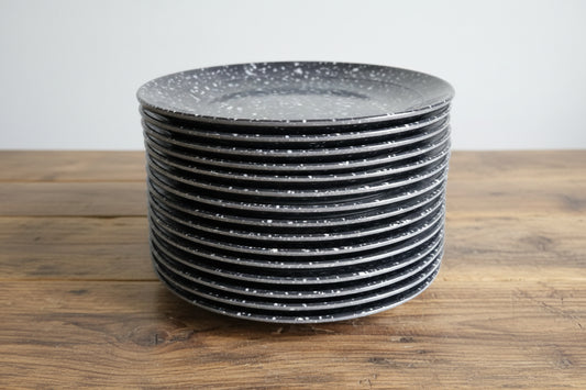 Stack of black circular objects on a wooden pallet